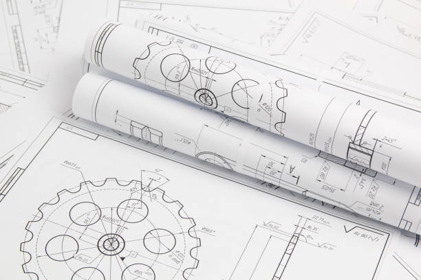 paper engineering drawings of industrial parts and mechanisms